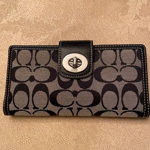 Black Coach wallet with checkbook.